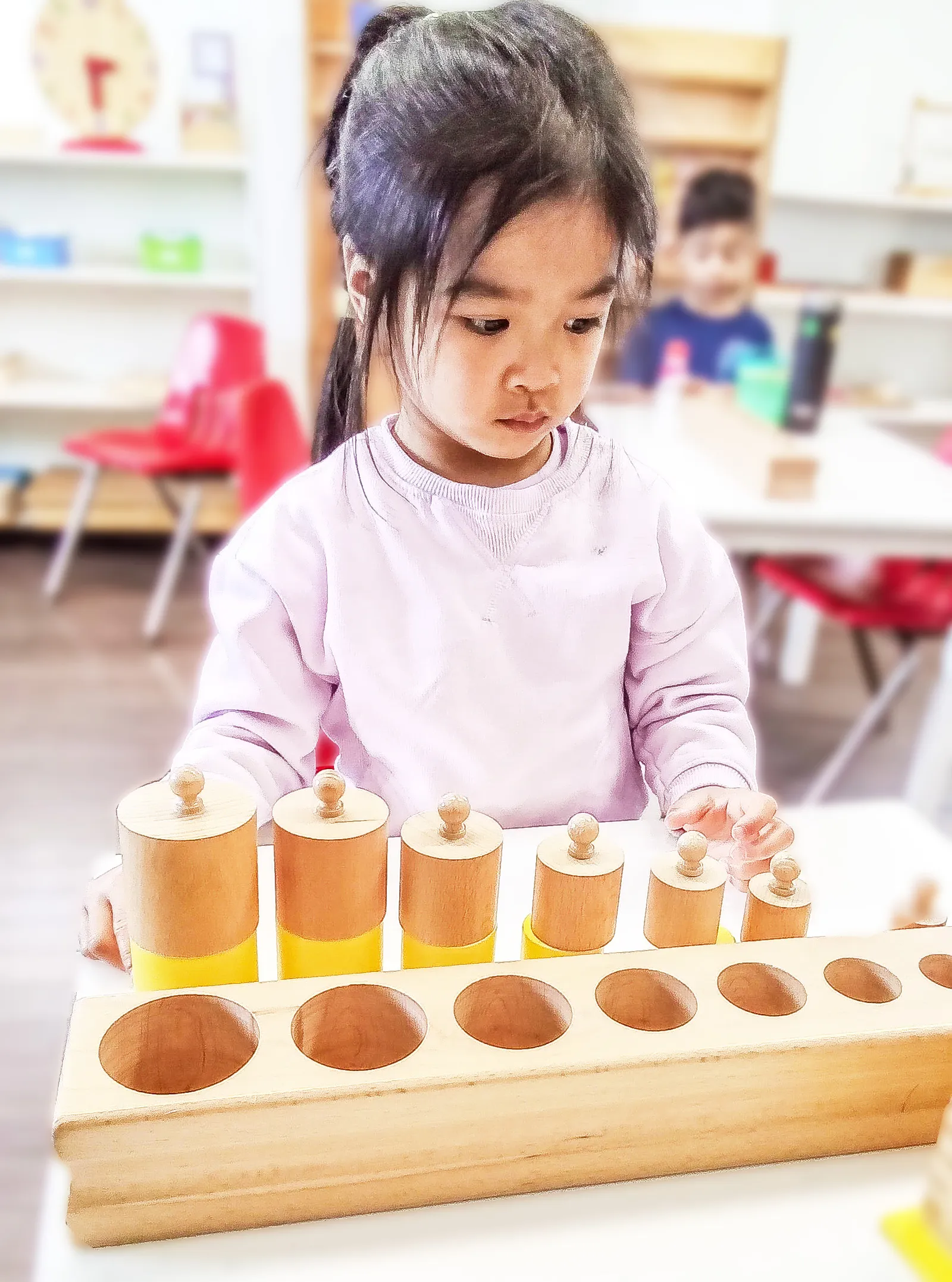 A child engaged in focused Montessori work.