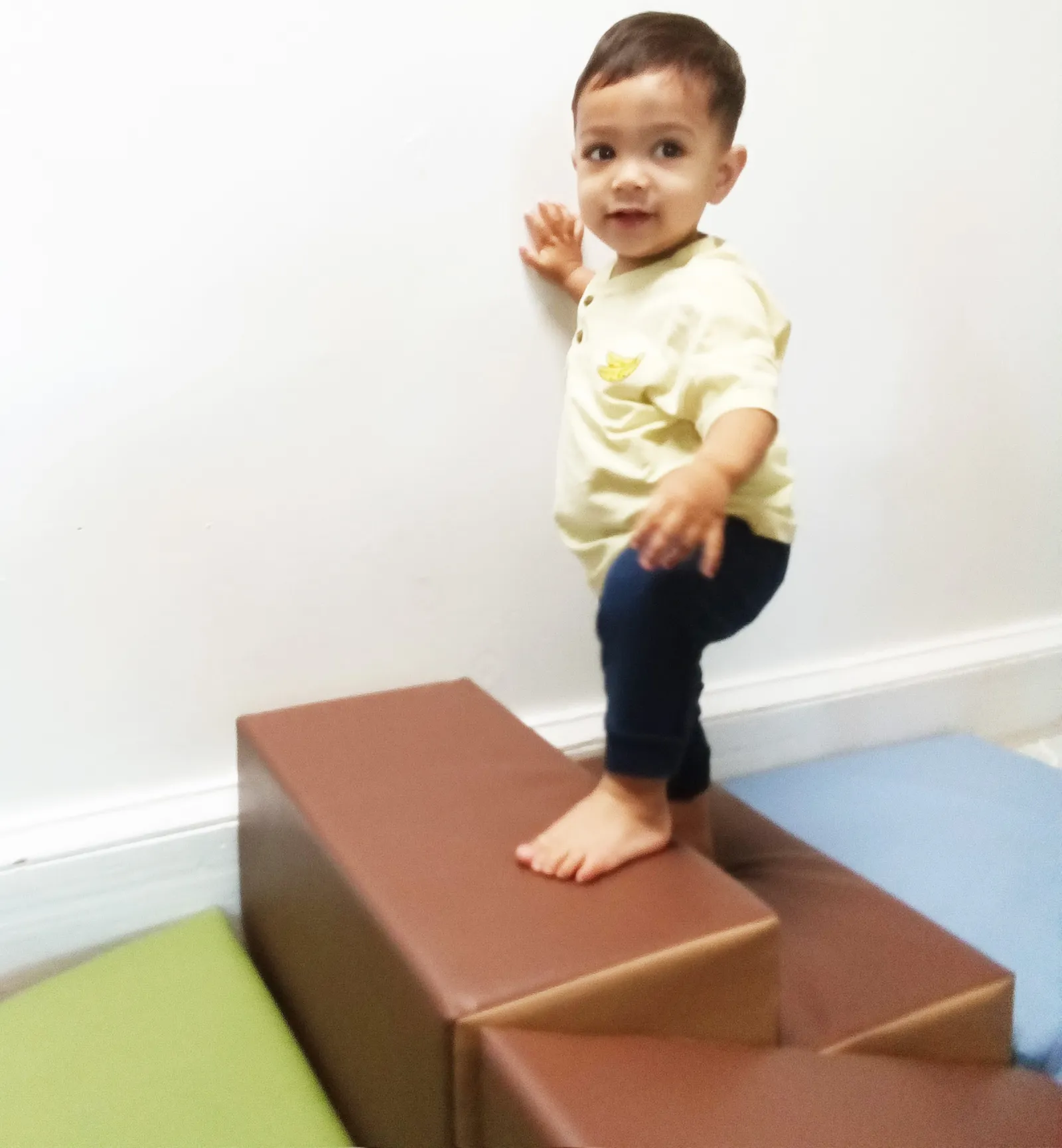 A toddler exploring a Montessori activity at their own pace.